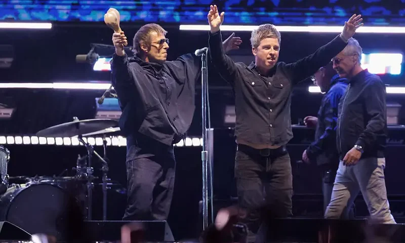 Liam Gallagher and Noel Gallagher from the British rock band Oasis, react during their Oasis Live '25 Tour at the Rose Bowl Stadium in Pasadena, California, U.S., September 6, 2025. REUTERS/Mario Anzuoni/File Photo