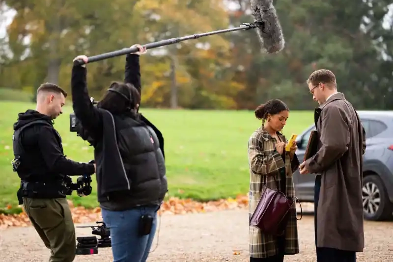 Antonia Thomas, second right, and and Josh Dylan, right appear during the filming of the Agatha Christie series “Tommy & Tuppence” in Beaconsfield, England on Wednesday, Oct. 29, 2025. (Photo by Scott A Garfitt/Invision/AP)