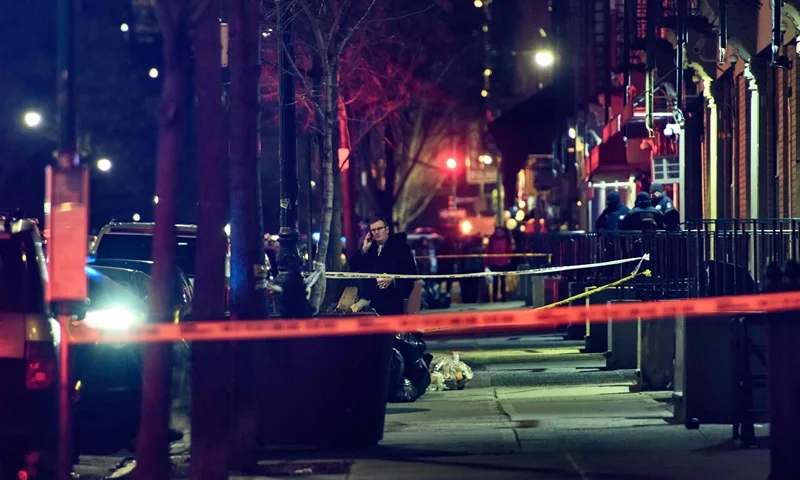 A general view shows the taped off area marking the scene of a shooting in Harlem, New York on January 22, 2022. - New York's mayor called on the federal government to help "stop the flow of weapons" in the city after a police officer was killed and another wounded in a shooting. (Photo by Ed JONES / AFP) (Photo by ED JONES/AFP via Getty Images)