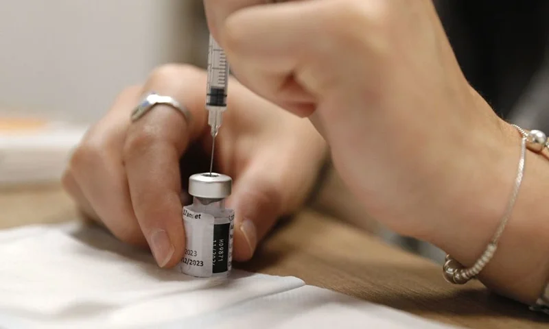 An employee prepares a dose of Comirnaty Omicron XBB 1.5 Pfizer vaccine for COVID-19 at a pharmacy in Ajaccio, on October 5, 2023, during a new COVID-19 vaccination campagin on the French Mediterranean island of Corsica. (Photo by Pascal POCHARD-CASABIANCA / AFP) (Photo by PASCAL POCHARD-CASABIANCA/AFP via Getty Images)