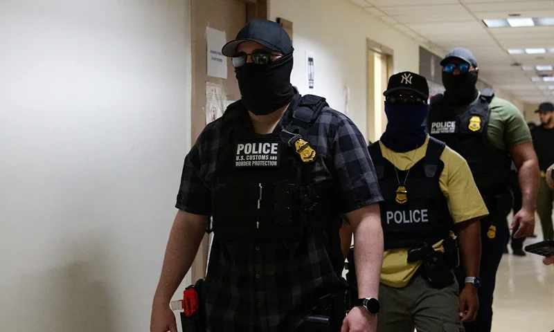 U.S. federal agents working for Immigration and Customs Enforcement (ICE) detain immigrants and asylum seekers reporting for immigration court proceedings at the Jacob K. Javits Federal Building's U.S. Immigration Court in New York, New York, Thursday, July 24, 2025. In recent weeks, masked agents have begun quickly detaining immigrants, and in some cases, U.S. citizens, at court houses for immediate detention and deportation. (Photo by Dominic Gwinn / Middle East Images via AFP) (Photo by DOMINIC GWINN/Middle East Images/AFP via Getty Images)