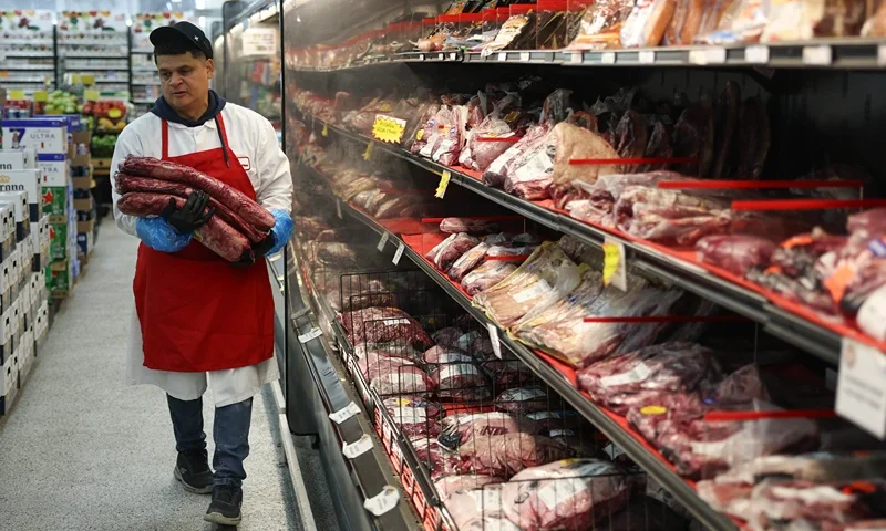 MIAMI, FLORIDA - JULY 22: Marlo Ramirez carries slabs of beef to be prepared for a customer in a grocery store on July 22, 2025 in Miami, Florida. Beef prices are hitting records, rising almost 9% since January, according to the Department of Agriculture. Industry experts say the increase in prices are due in part to drought conditions across the country that have caused herds to shrink, while the demand for beef continues to increase. (Photo by Joe Raedle/Getty Images)