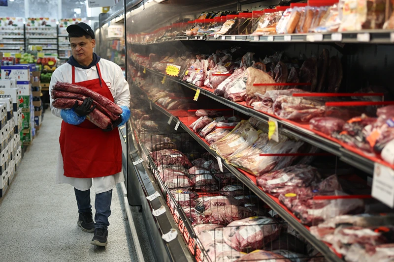 MIAMI, FLORIDA - JULY 22: Marlo Ramirez carries slabs of beef to be prepared for a customer in a grocery store on July 22, 2025 in Miami, Florida. Beef prices are hitting records, rising almost 9% since January, according to the Department of Agriculture. Industry experts say the increase in prices are due in part to drought conditions across the country that have caused herds to shrink, while the demand for beef continues to increase. (Photo by Joe Raedle/Getty Images)