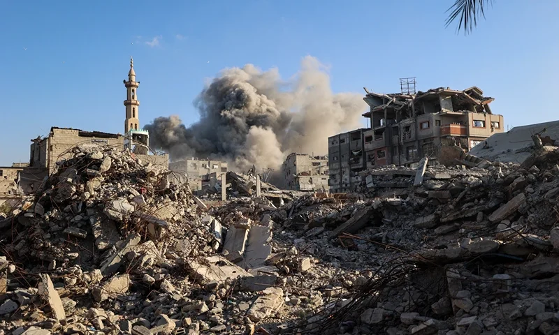 TOPSHOT - Smoke billows following an Israeli strike that targeted a building in the Bureij camp for Palestinian refugees in the central Gaza Strip on October 19, 2025. Gaza's civil defence agency said a series of Israeli air strikes on October 19 killed at least 11 people across the territory, as Israel and Hamas traded blame for violating a ceasefire. (Photo by Eyad BABA / AFP) (Photo by EYAD BABA/AFP via Getty Images)