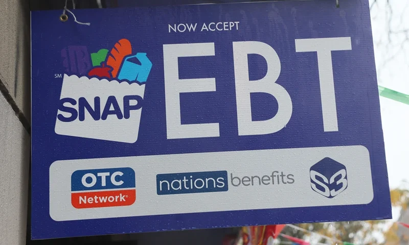 NEW YORK, NEW YORK - OCTOBER 30: An EBT sign is displayed on the window of a grocery store on October 30, 2025 in the Flatbush neighborhood of the Brooklyn borough in New York City. Supplemental Nutrition Assistance Program (SNAP) benefits and other assistance are set to stop on November 1st amid a federal government shutdown that has been going on for 29 days and is the second-longest shutdown in the nation's history. New York Gov. Kathy Hochul declared a state of emergency for extra emergency funds and personnel to be deployed, as SNAP payments will be suspended. About 42 million Americans are expected to lose access to their benefits. (Photo by Michael M. Santiago/Getty Images)