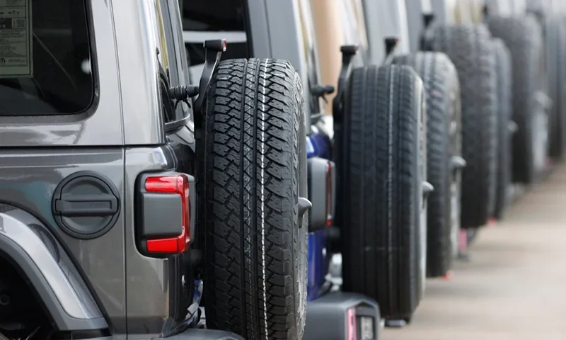 Spare tires are seen on a long row of unsold 2020 Wranglers sit at a Jeep dealership in Englewood, Colo., on April 26, 2020. (AP Photo/David Zalubowski, File)