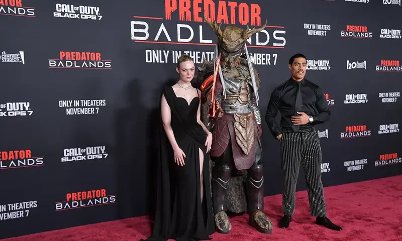 Dimitrius Schuster-Koloamatangi, left, and Elle Fanning arrive at the premiere of “Predator: Badlands” on Monday, Nov. 3, 2025, at TCL Chinese Theatre in Los Angeles. (Photo by Richard Shotwell/Invision/AP)