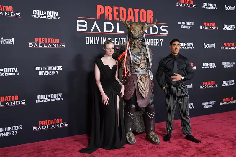 Dimitrius Schuster-Koloamatangi, left, and Elle Fanning arrive at the premiere of “Predator: Badlands” on Monday, Nov. 3, 2025, at TCL Chinese Theatre in Los Angeles. (Photo by Richard Shotwell/Invision/AP)